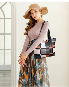 Detail of checkered tote bag featuring black shoulder straps and spacious nylon interior
