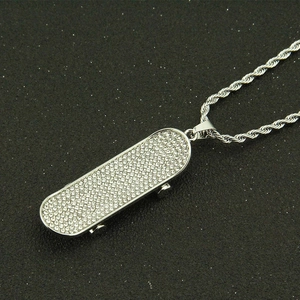 Men's silver skateboard pendant necklace with sparkling crystals on black background