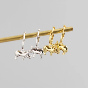 Detailed view of 3D rhinoceros pendants on silver and gold hoop earrings in S925 sterling silver