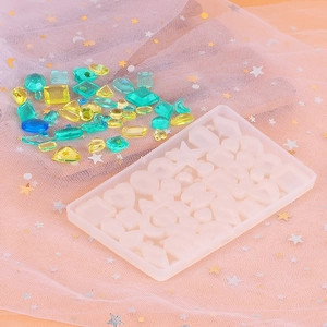Translucent silicone mold for DIY geometric crystal resin pendants on pink mesh