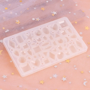 Detailed view of translucent silicone mold with heart and geometric shapes for DIY jewelry