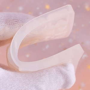 Flexible silicone jewelry mold being bent to demonstrate high elasticity for DIY resin crafts