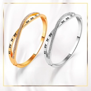 Detailed view of intertwined Roman numeral bracelets with crystal pave in rose gold and silver