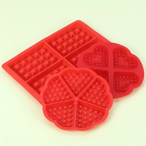 Close-up of heart and square shaped silicone waffle molds in food grade red silicone