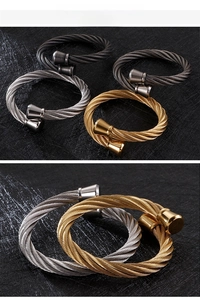 Macro detail of twisted steel cable bracelets with cone metal clasps in four finishes
