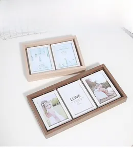 Detail of 360-degree rotating double-sided wooden photo frames in oak and walnut finishes