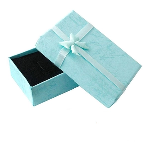 Light blue jewelry gift box with a satin ribbon bow and a black velvet interior foam insert