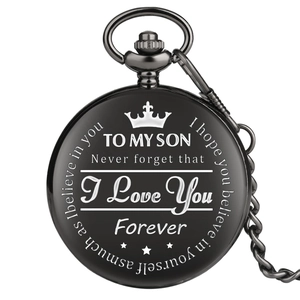 Detailed engraving on black pocket watch cover featuring crown and sentimental message