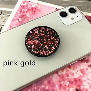 Detail of round expanding phone socket holder featuring sparkling rose gold foil inlay
