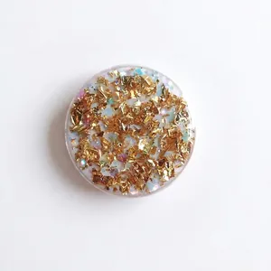 Round glitter phone socket with gold leaf and colorful sequins in clear resin