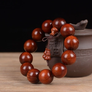 Detail of 20mm dark sandalwood prayer beads with 12 pieces and a traditional knot