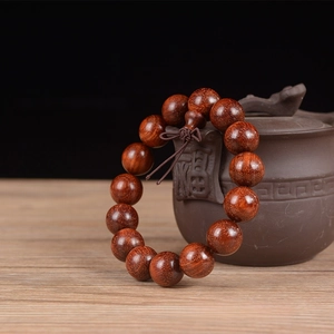 Detailed macro view of 15mm Sandalwood beads with high-density gold star textures