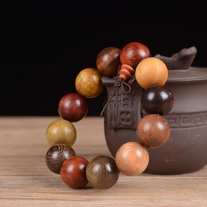 Macro detail of 20mm mixed wood bead bracelet with 12 beads and traditional knot