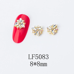 Detailed macro view of 8x8mm gold flower nail art charm with AB colorful rhinestones