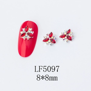 Detailed view of 3D metal flower nail art charms with red rhinestones in 8x8mm size