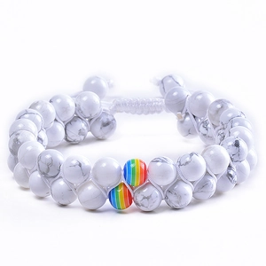 Close-up of dual-layer white turquoise beads with rainbow accent and woven cord detail