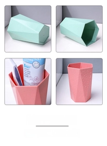 Detail of geometric wheat straw toothbrush cups in mint green and pink colors