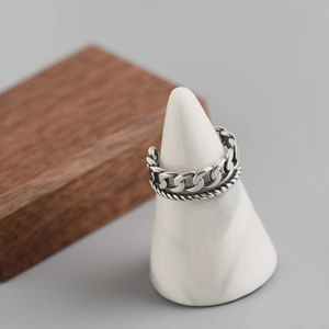 Double-layered S925 sterling silver chain ring with braided twist design on display