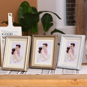 Modern photo frame set with beaded inner edge in gold, wood, and blue finishes