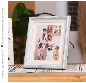 Detail of white vintage wood grain photo frame with elegant floral carving in Nordic style