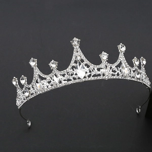 Macro detail of luxury silver tiara with sparkling crystal rhinestones on black background