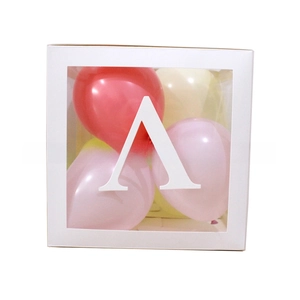 Close-up of a white decorative gift box with transparent window and letter A sticker