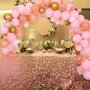 Close-up of four transparent boxes with white borders spelling BABY for party decor