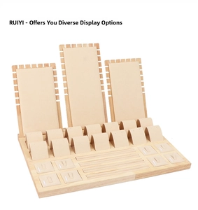 Detail view of wooden jewelry display set with microfiber pads for necklaces and rings