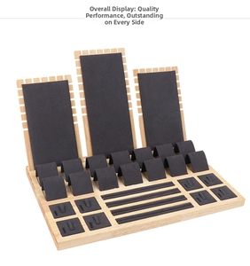 Detail view of wooden jewelry display set with black velvet padding for rings and necklaces