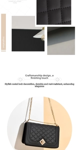 Detailed view of quilted black leather texture and gold metal chain strap on a luxury bag