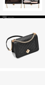 Detail of black quilted chain bag with gold hardware and multi-layer inner compartments