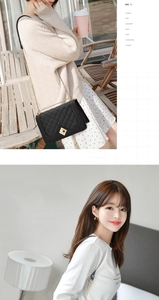 Detail of classic black quilted leather chain bag with golden metal hardware and clasp