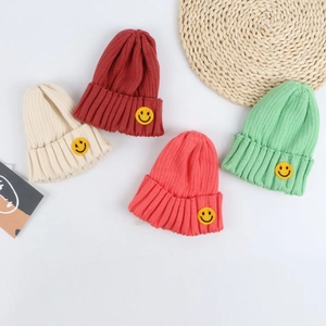 Classic knitted beanies in four macaron colors featuring yellow smiley face patches