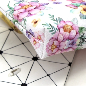 Close-up of the unicorn coin purse showing the floral canvas texture and stitching