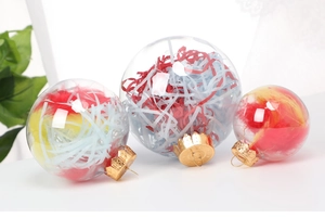 Three clear plastic Christmas ornaments filled with colorful feathers and gold caps