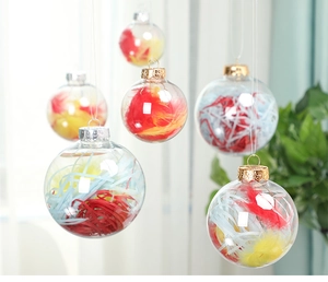 Close-up of clear plastic Christmas balls filled with colorful red and blue feathers