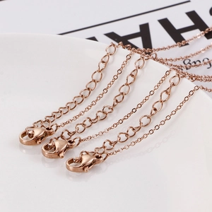 Detail of rose gold plated chains with lobster clasps and hollow heart pendant charms
