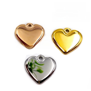 Three heart-shaped metal pendants in gold, rose gold, and silver with high mirror polish