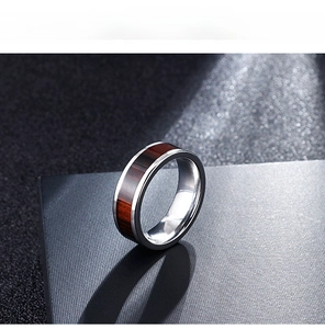 Close-up of silver stainless steel ring with elegant red-brown wood inlay detail