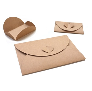 Detailed view of vintage kraft paper envelopes and heart-shaped folding card sleeves