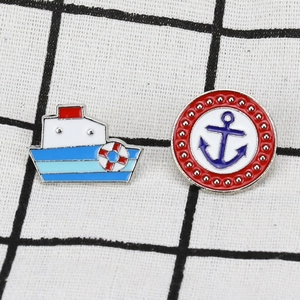 Navy style enamel pin set featuring a white ship and a round blue anchor on metal base