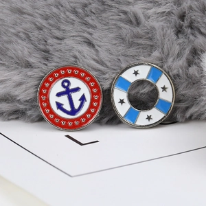 Macro shot of nautical theme pins featuring blue anchor and star on enamel metal badges