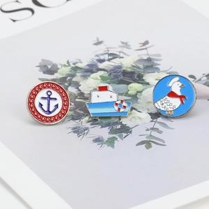 Detailed macro view of enamel pins featuring anchor, boat, and cartoon duck motifs