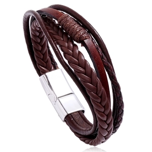 Detail view of multi-layer brown woven leather bracelet with polished silver magnetic clasp