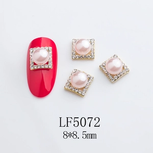 Detail of pink pearl nail charms with gold metal base and rhinestones, size 8x8.5mm