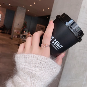 Elegant rose gold ring with micro-pave crystals shown in a social setting