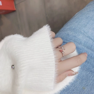 Close-up of rose gold open ring with pink heart crystal and white cubic zirconia stones