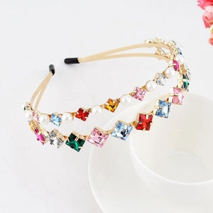 Detail view of double-layer gold headband with colorful crystals and white pearls