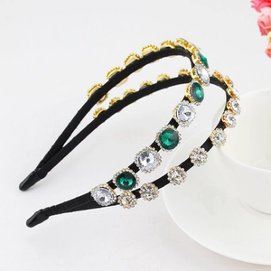 Detail of baroque headbands with emerald green rhinestones and faux pearl embellishments