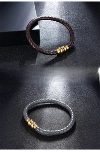 Close-up of woven microfiber leather bracelets in brown and grey with gold metal clasps